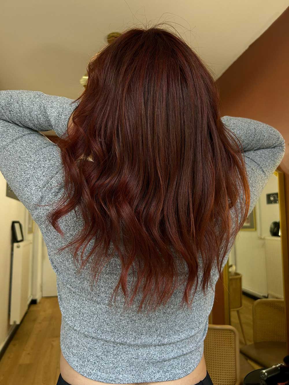 Une femme vue de dos qui montre sa coupe de cheveux avec une coloration réalisée par le coiffeur à Bordeaux Dissemblance